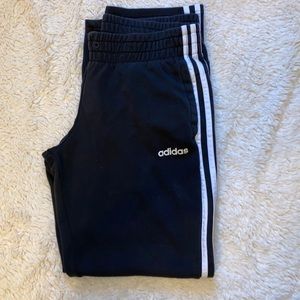 black adidas sweatpants with 3 white stripes. size M.